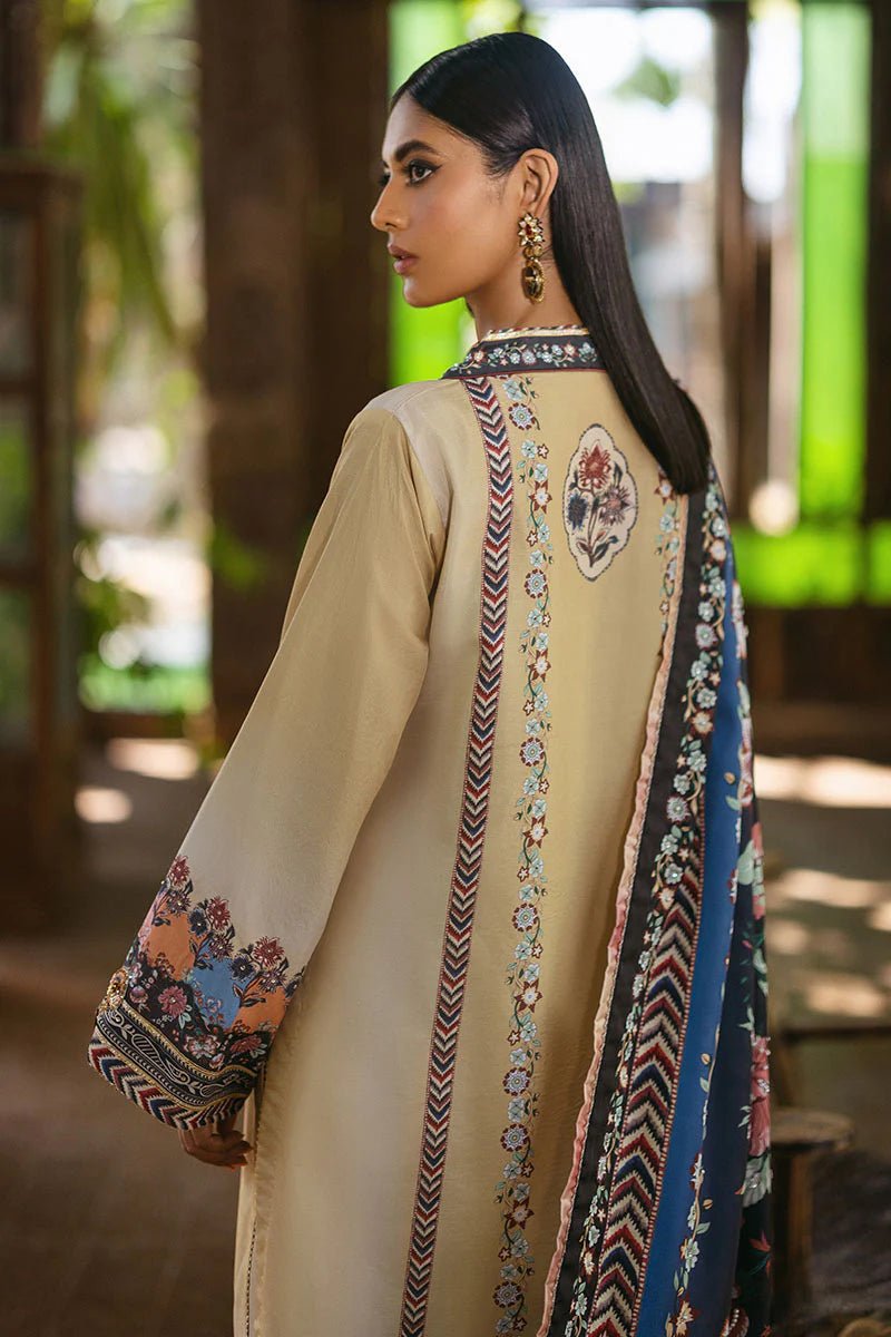 Model wearing Taupe dress from Mushq's Nirvana Silk Edit in soft beige with intricate floral patterns and navy accents. Pakistani winter casual pret clothes available online in the UK.