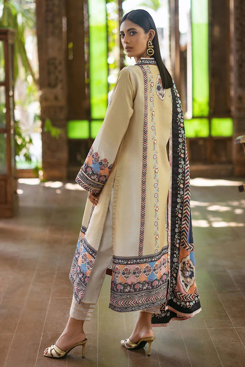 Model wearing Taupe dress from Mushq's Nirvana Silk Edit in soft beige with intricate floral patterns and navy accents. Pakistani winter casual pret clothes available online in the UK.