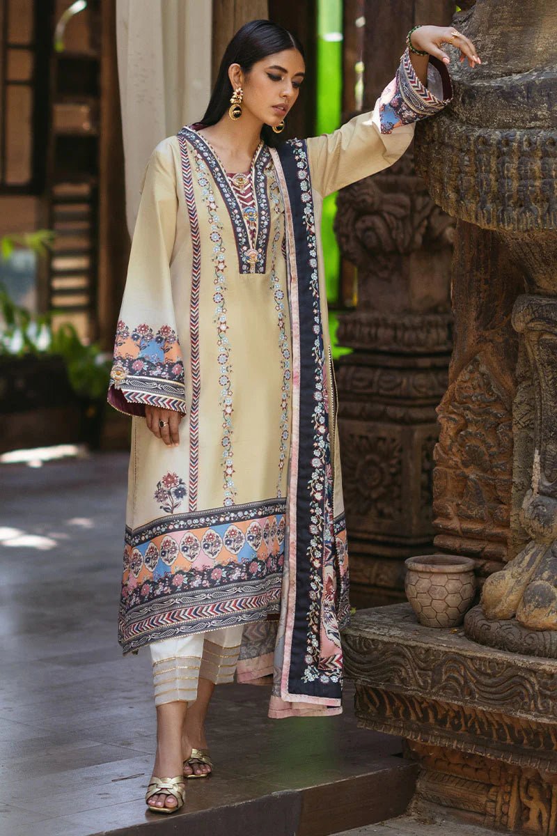 Model wearing Taupe dress from Mushq's Nirvana Silk Edit in soft beige with intricate floral patterns and navy accents. Pakistani winter casual pret clothes available online in the UK.