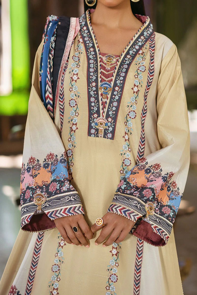 Model wearing Taupe dress from Mushq's Nirvana Silk Edit in soft beige with intricate floral patterns and navy accents. Pakistani winter casual pret clothes available online in the UK.