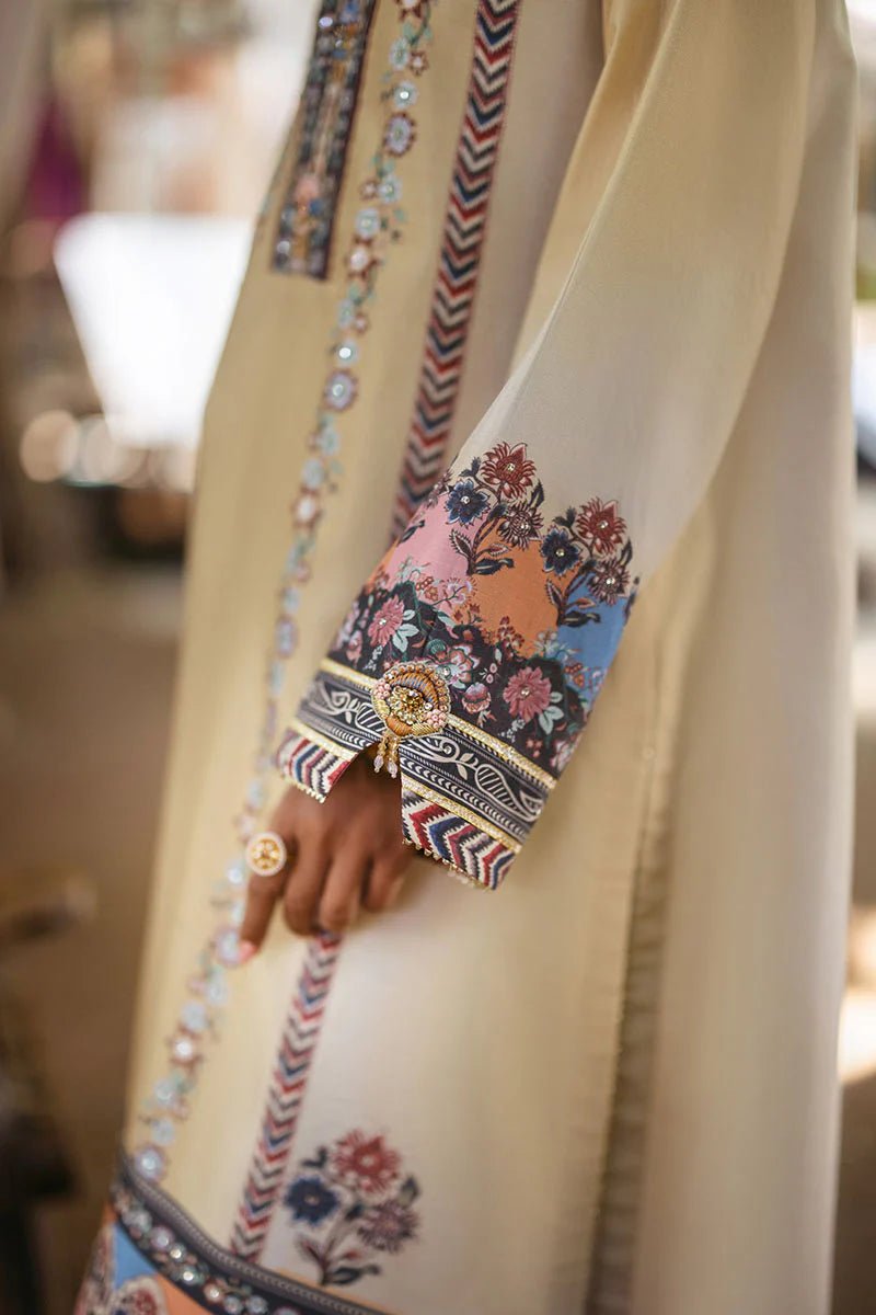 Model wearing Taupe dress from Mushq's Nirvana Silk Edit in soft beige with intricate floral patterns and navy accents. Pakistani winter casual pret clothes available online in the UK.