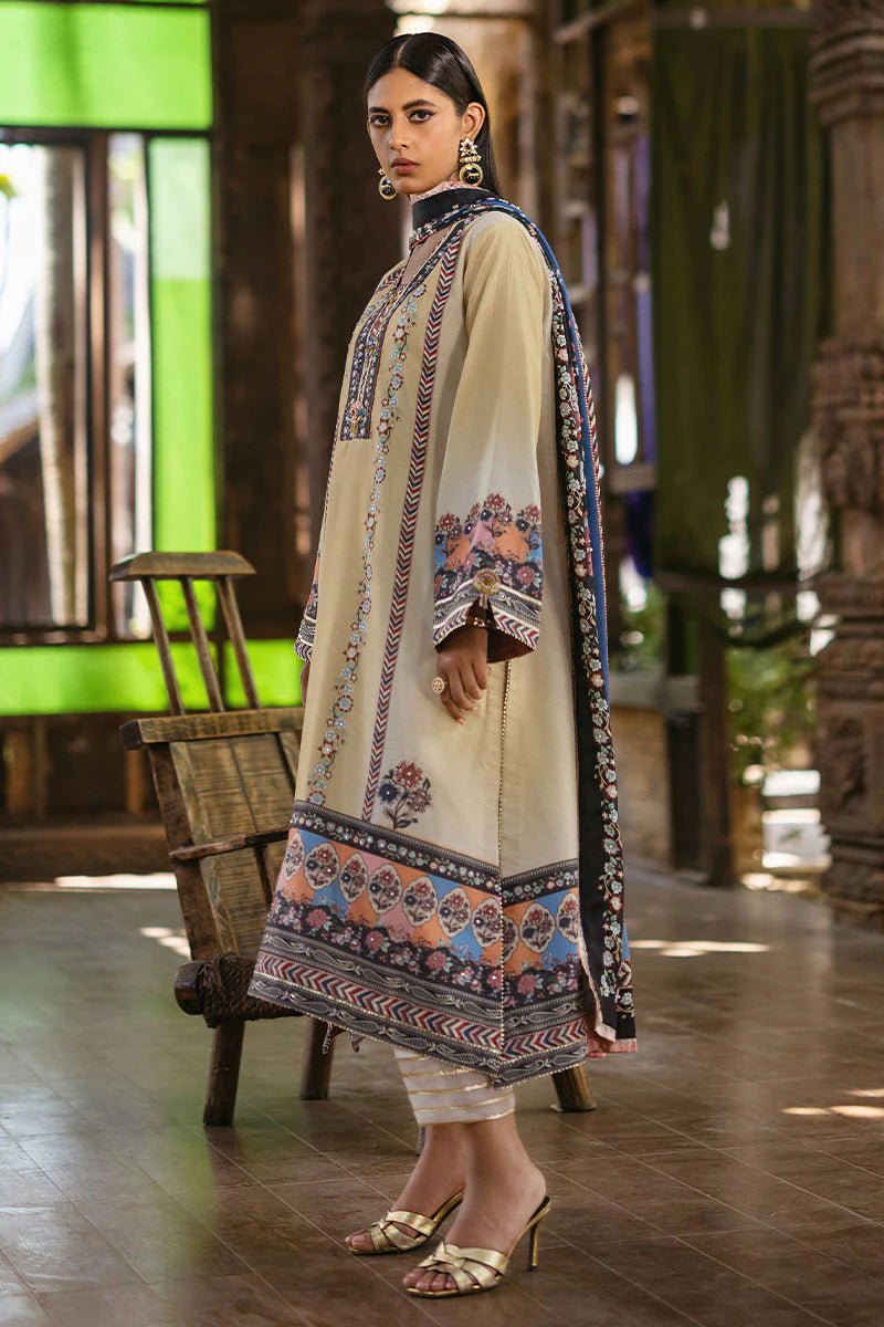 Model wearing Taupe dress from Mushq's Nirvana Silk Edit in soft beige with intricate floral patterns and navy accents. Pakistani winter casual pret clothes available online in the UK.