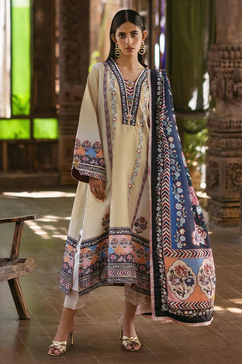 Model wearing Taupe dress from Mushq's Nirvana Silk Edit in soft beige with intricate floral patterns and navy accents. Pakistani winter casual pret clothes available online in the UK.