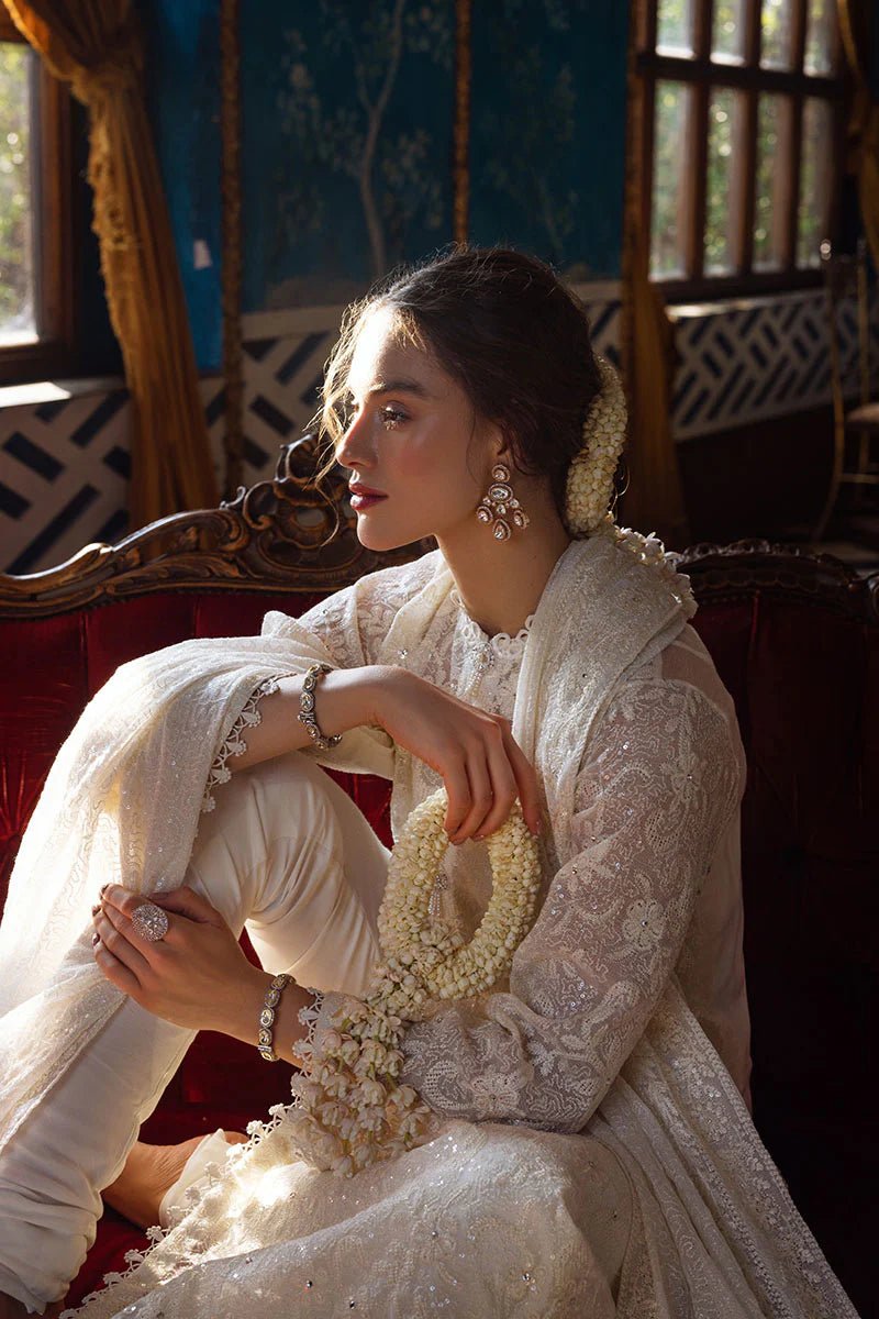 Model wearing ivory LADAN dress from Mushq, Saugaat Chickenkari Pret collection. Pakistani designer clothes in UK, readymade clothes, elegant and stylish.