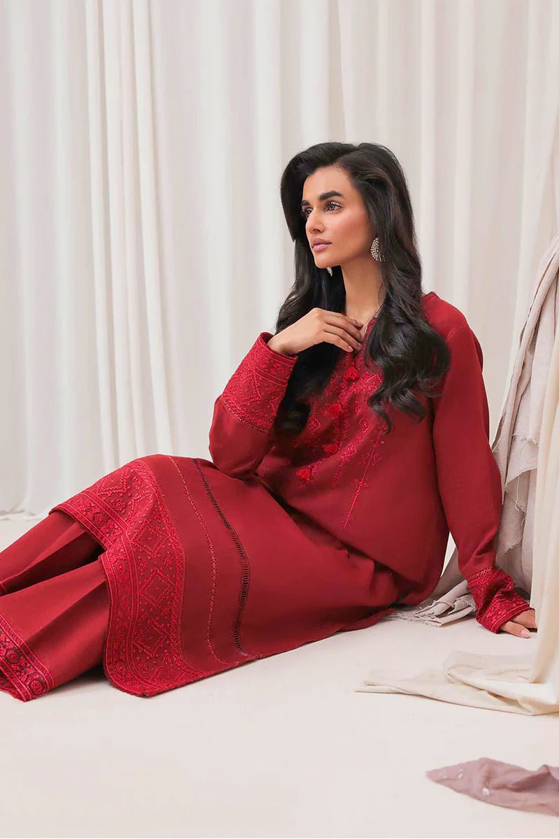 Model wearing Mushq Wisteria Winter Basic Pret '24 Red Wonder, a vibrant red dress with intricate embroidery, perfect for winter casual wear. Available for Pakistani clothes online in the UK.