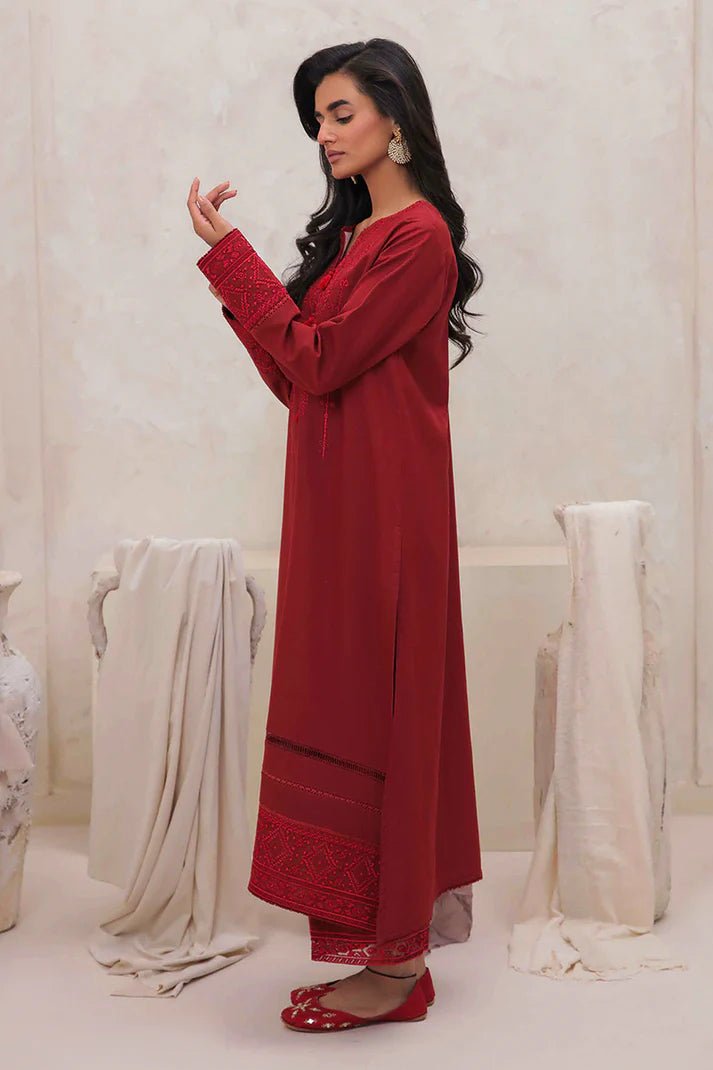 Model wearing Mushq Wisteria Winter Basic Pret '24 Red Wonder, a vibrant red dress with intricate embroidery, perfect for winter casual wear. Available for Pakistani clothes online in the UK.