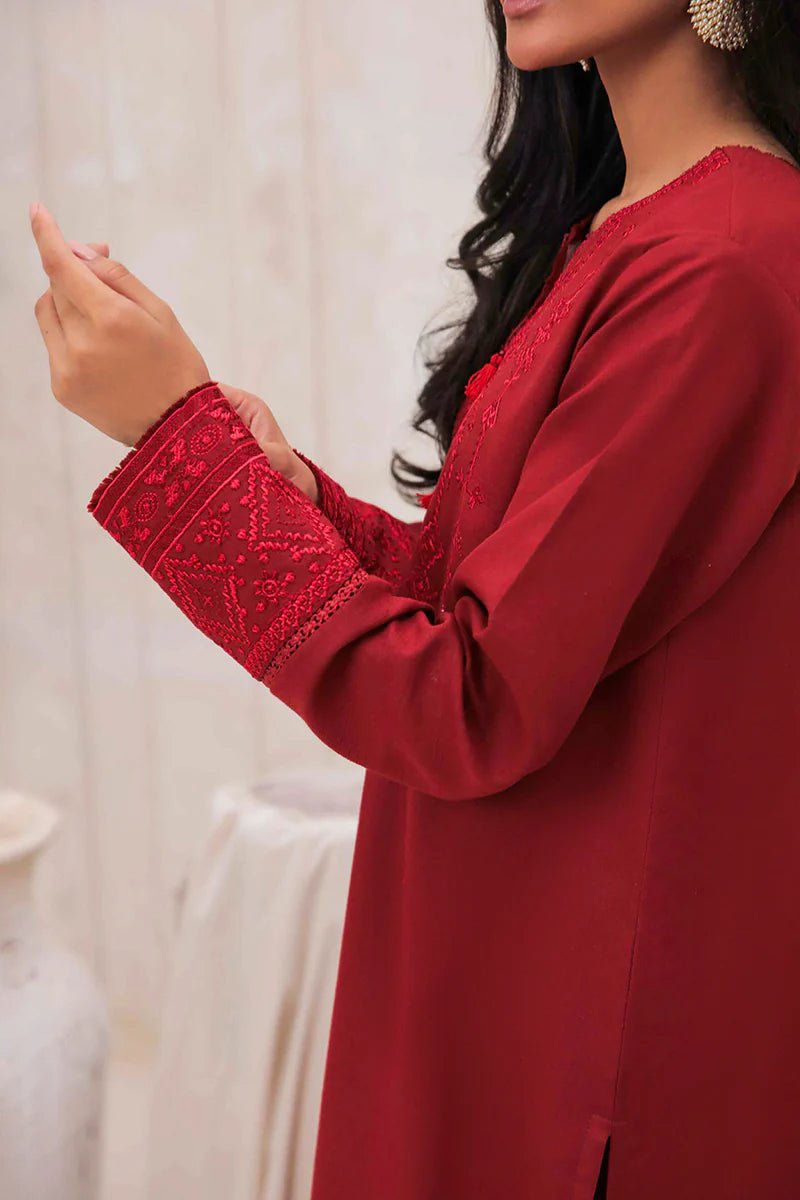 Model wearing Mushq Wisteria Winter Basic Pret '24 Red Wonder, a vibrant red dress with intricate embroidery, perfect for winter casual wear. Available for Pakistani clothes online in the UK.