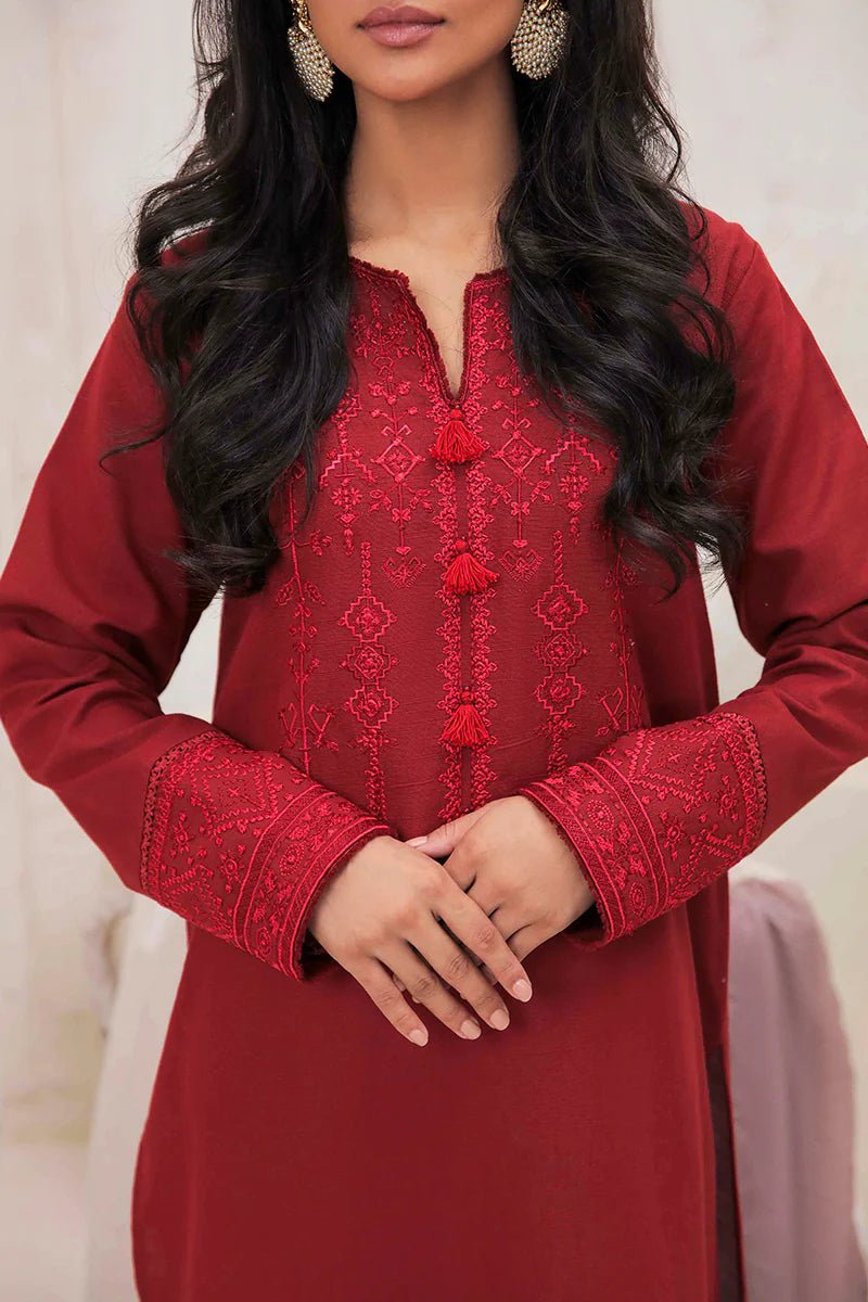 Model wearing Mushq Wisteria Winter Basic Pret '24 Red Wonder, a vibrant red dress with intricate embroidery, perfect for winter casual wear. Available for Pakistani clothes online in the UK.