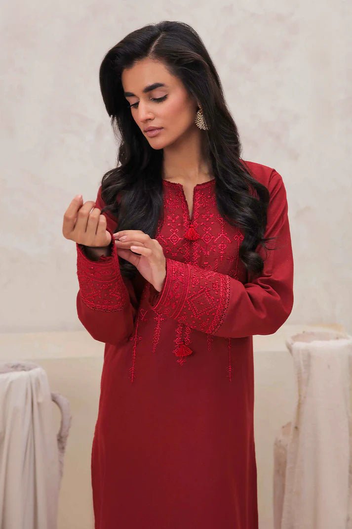 Model wearing Mushq Wisteria Winter Basic Pret '24 Red Wonder, a vibrant red dress with intricate embroidery, perfect for winter casual wear. Available for Pakistani clothes online in the UK.
