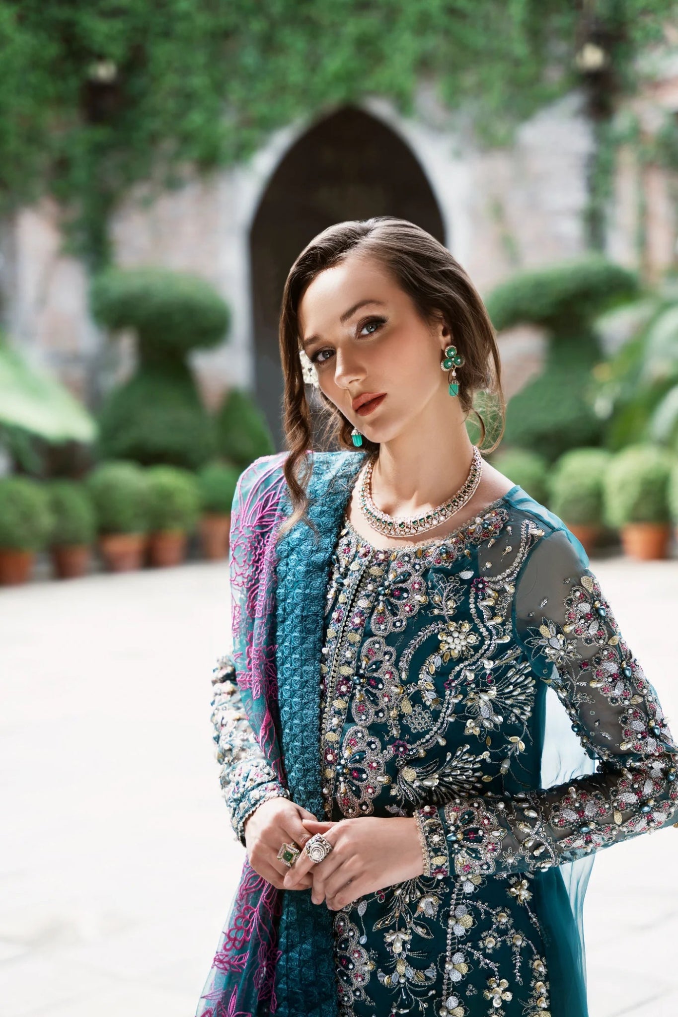Model wearing Mysie by Tahira AROOB dress in teal, showcasing intricate embroidery and elegant design, perfect for weddings. showcasing Pakistani clothes online in the UK at Signature Labels