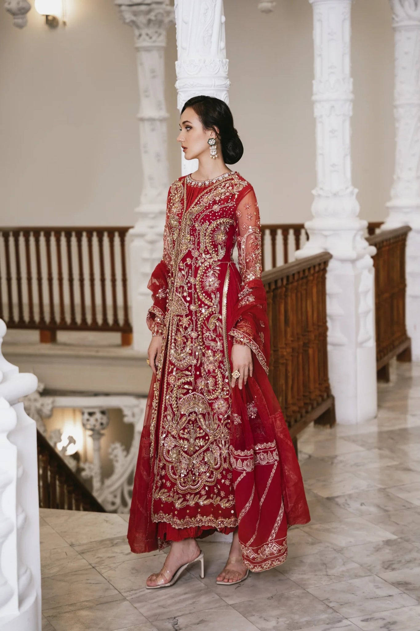 Model wearing a red embellished HAZE dress from Mysie by Tahira. The dress features intricate gold embroidery and sequins, perfect for wedding clothes