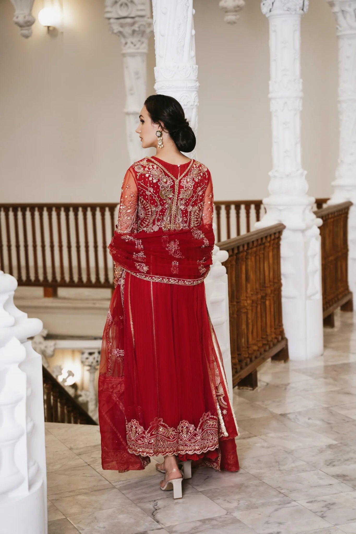 Model wearing a red embellished HAZE dress from Mysie by Tahira. The dress features intricate gold embroidery and sequins, perfect for wedding clothes