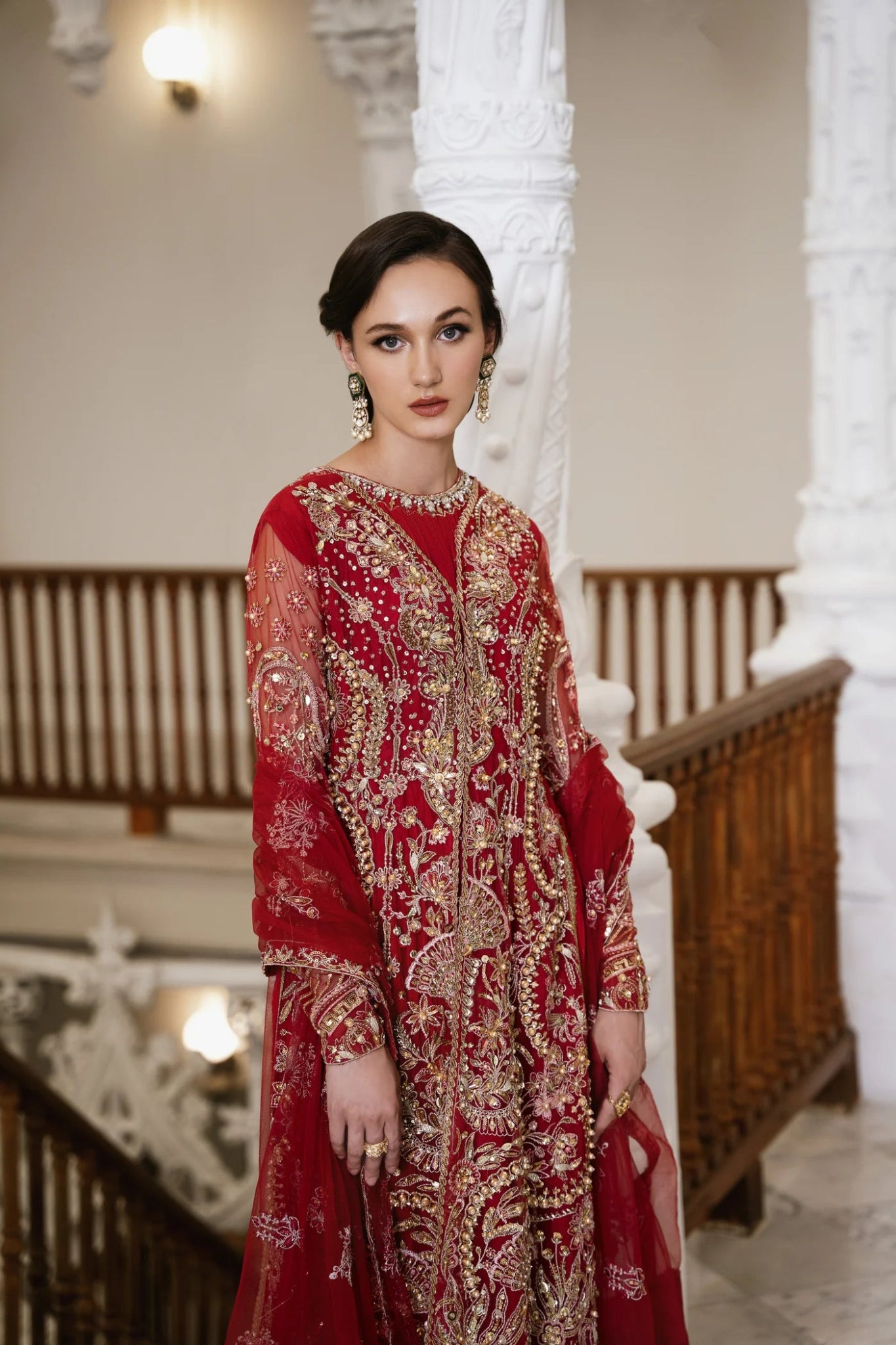 Model wearing a red embellished HAZE dress from Mysie by Tahira. The dress features intricate gold embroidery and sequins, perfect for wedding clothes