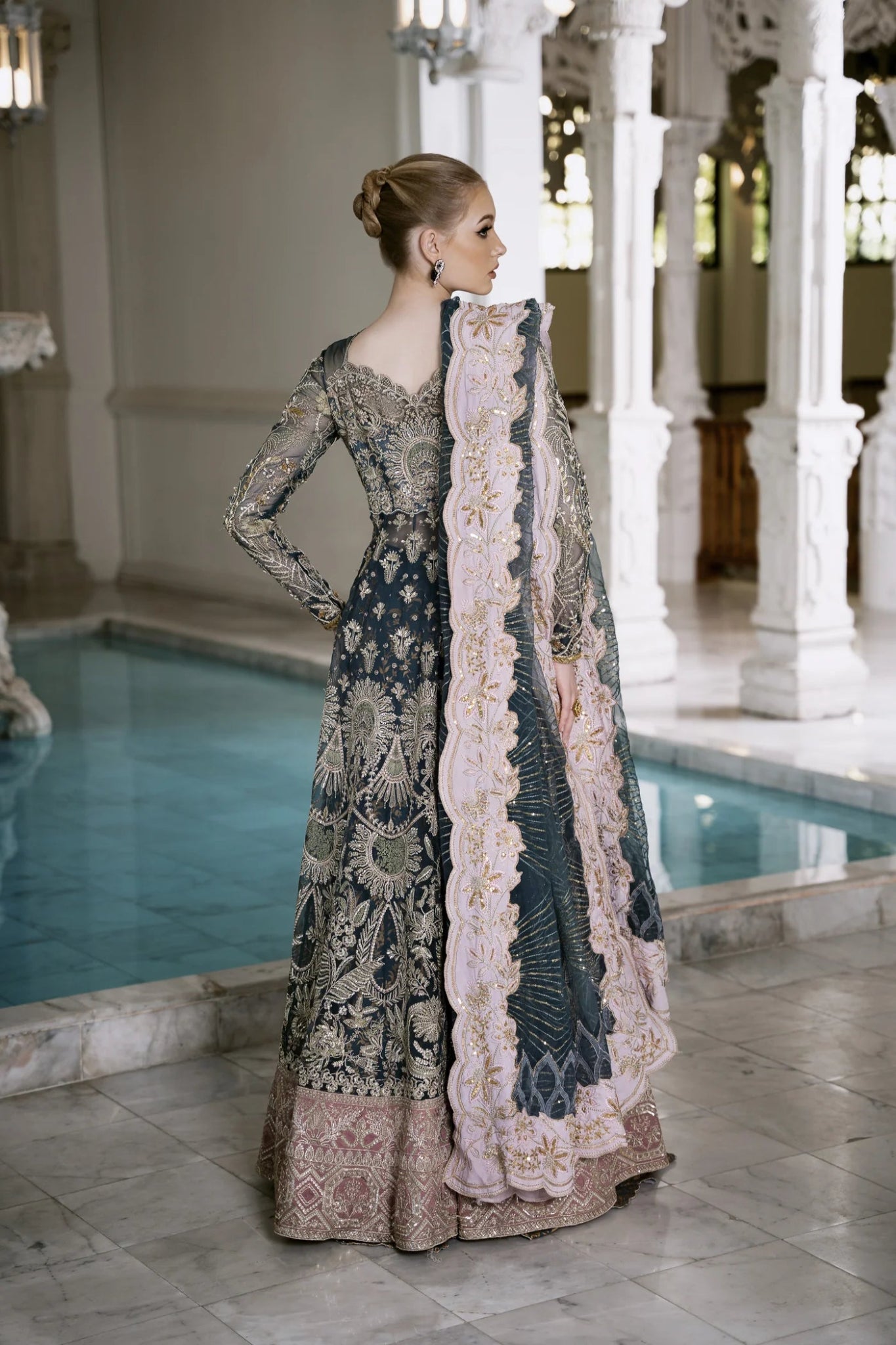 Model wearing Mysie by Tahira RAHA dress in blue, showcasing intricate embroidery and luxurious design. Perfect for weddings.