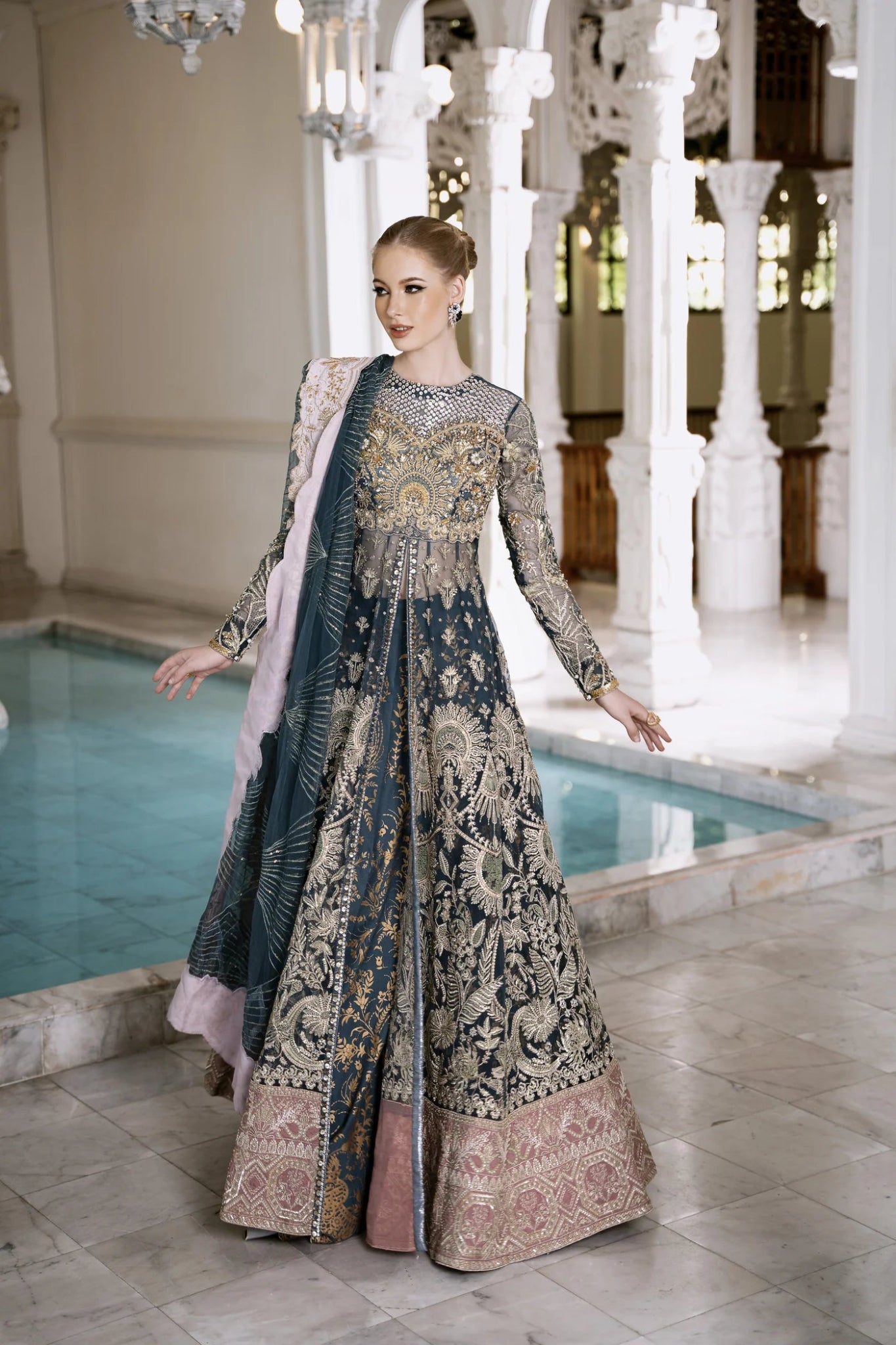 Model wearing Mysie by Tahira RAHA dress in blue, showcasing intricate embroidery and luxurious design. Perfect for weddings.