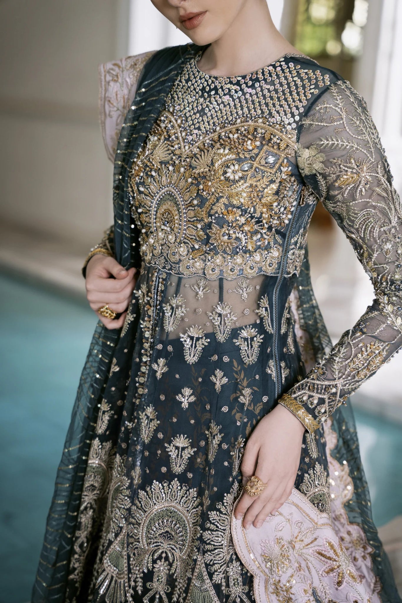 Model wearing Mysie by Tahira RAHA dress in blue, showcasing intricate embroidery and luxurious design. Perfect for weddings.
