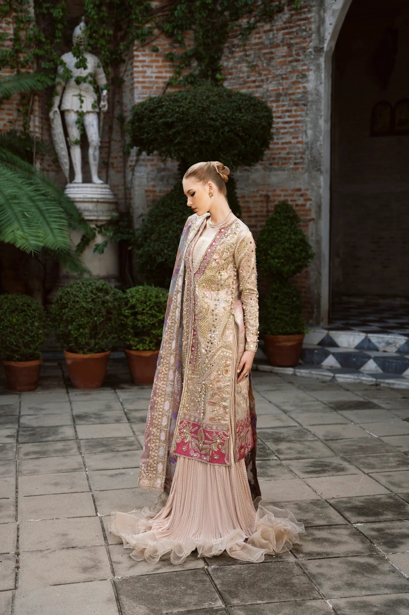 Model wearing a multicolored SHABANA dress with intricate embroidery, featuring shades of beige and red, from Mysie by Tahira. Perfect for Pakistani wedding clothes online in the UK.