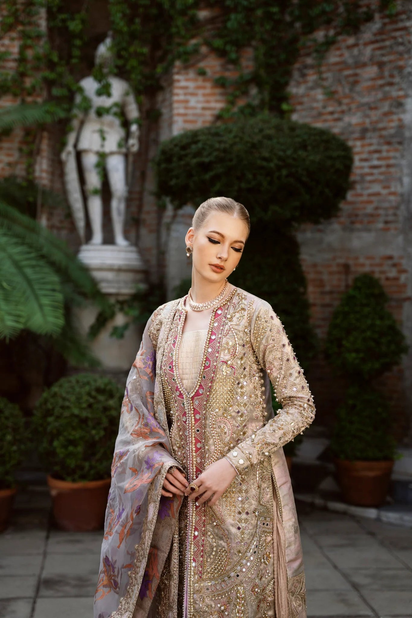 Model wearing a multicolored SHABANA dress with intricate embroidery, featuring shades of beige and red, from Mysie by Tahira. Perfect for Pakistani wedding clothes online in the UK.