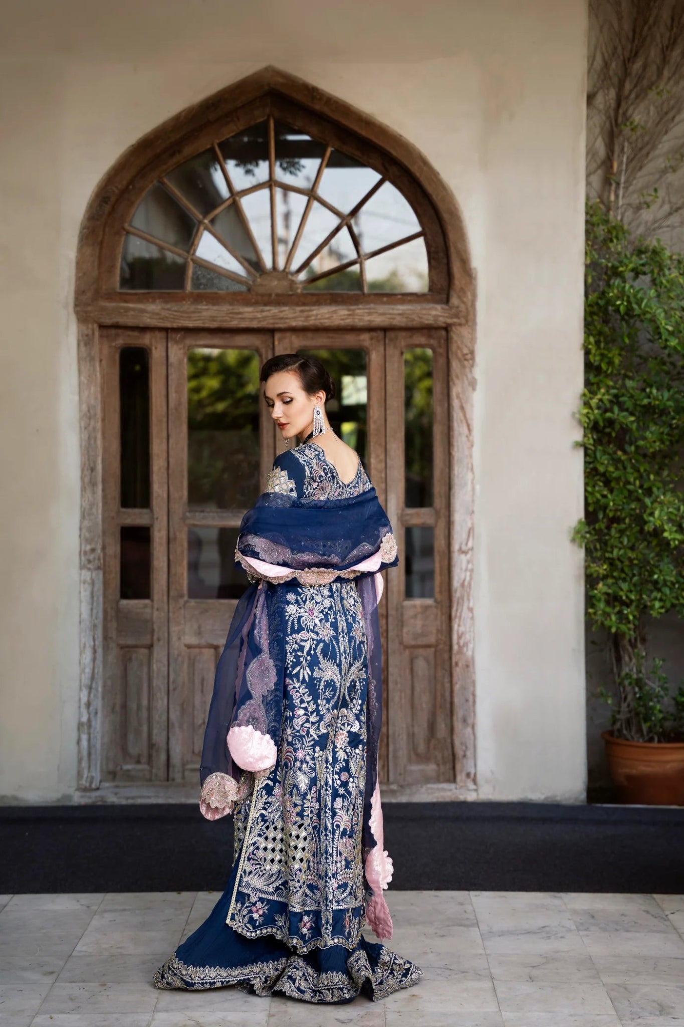 Model wearing a navy blue embroidered SIAMESE dress from Mysie by Tahira. Perfect for weddings. Pakistani clothes online in UK.