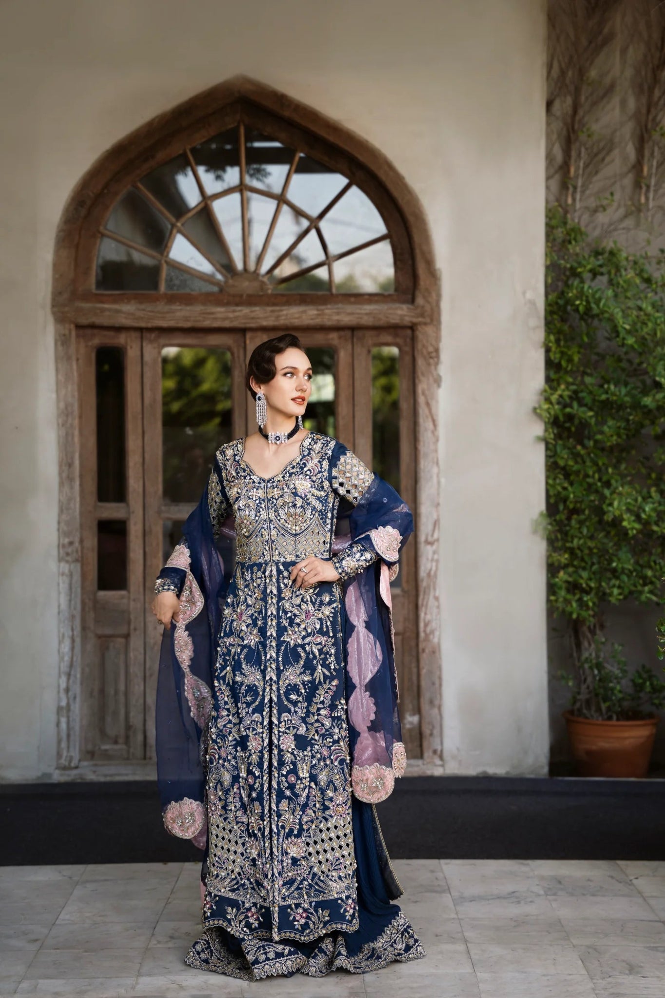 Model wearing a navy blue embroidered SIAMESE dress from Mysie by Tahira. Perfect for weddings. Pakistani clothes online in UK.