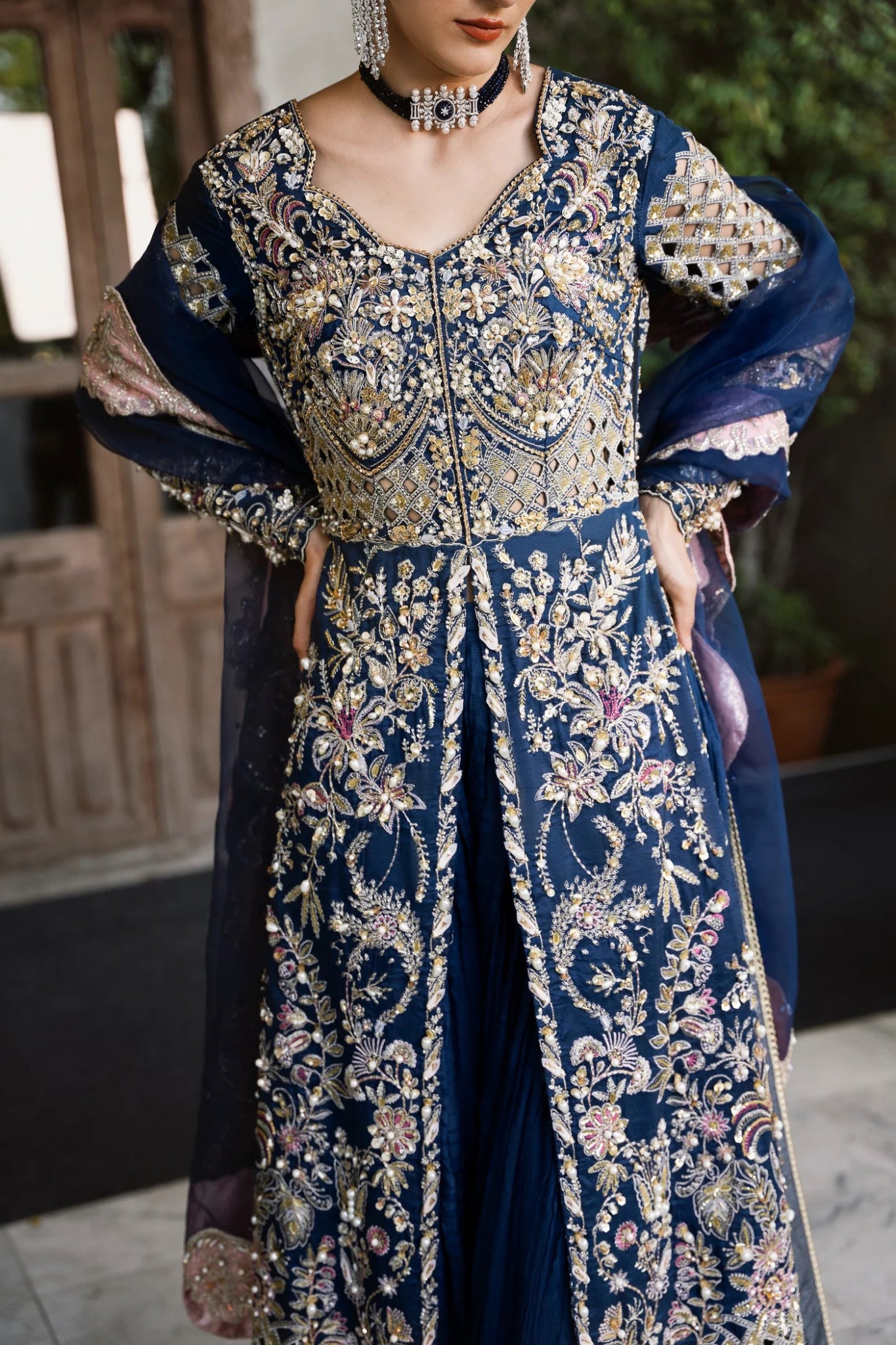 Model wearing a navy blue embroidered SIAMESE dress from Mysie by Tahira. Perfect for weddings. Pakistani clothes online in UK.