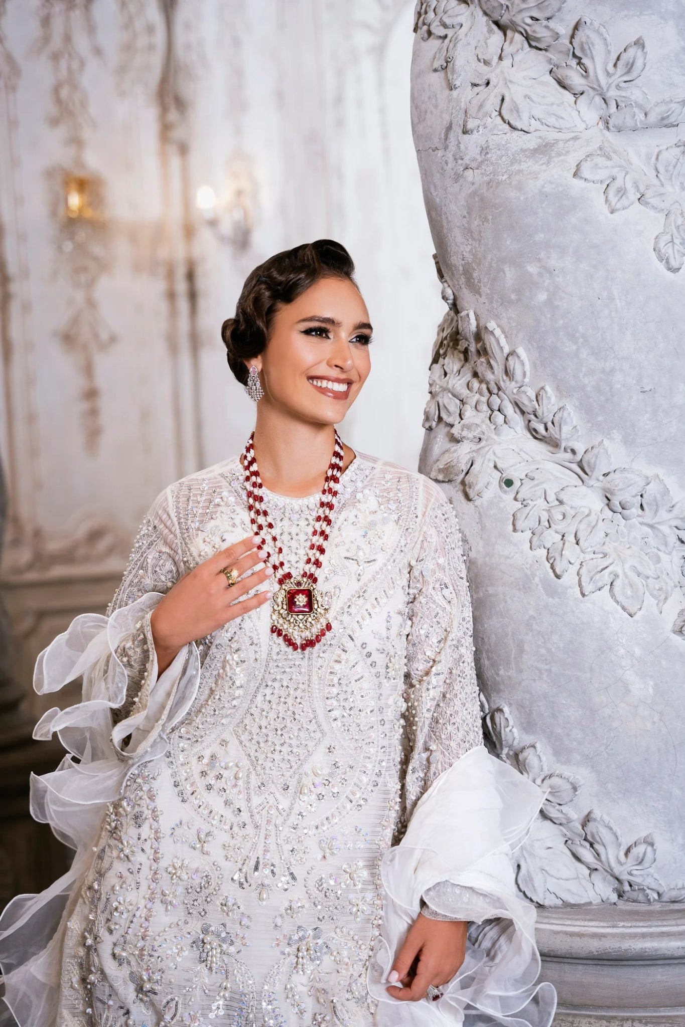 Model wearing SUZANNA ivory dress from Mysie by Tahira, featuring intricate silver embroidery and ruffled sleeves. Ideal for weddings. Find Pakistani clothes online in UK.