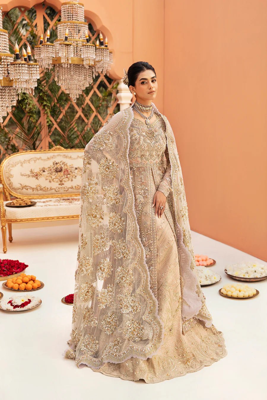 Model in Mysie By Tahira Cynthia gown, champagne gold with opulent detailing, a UK Pakistani clothes gem.
