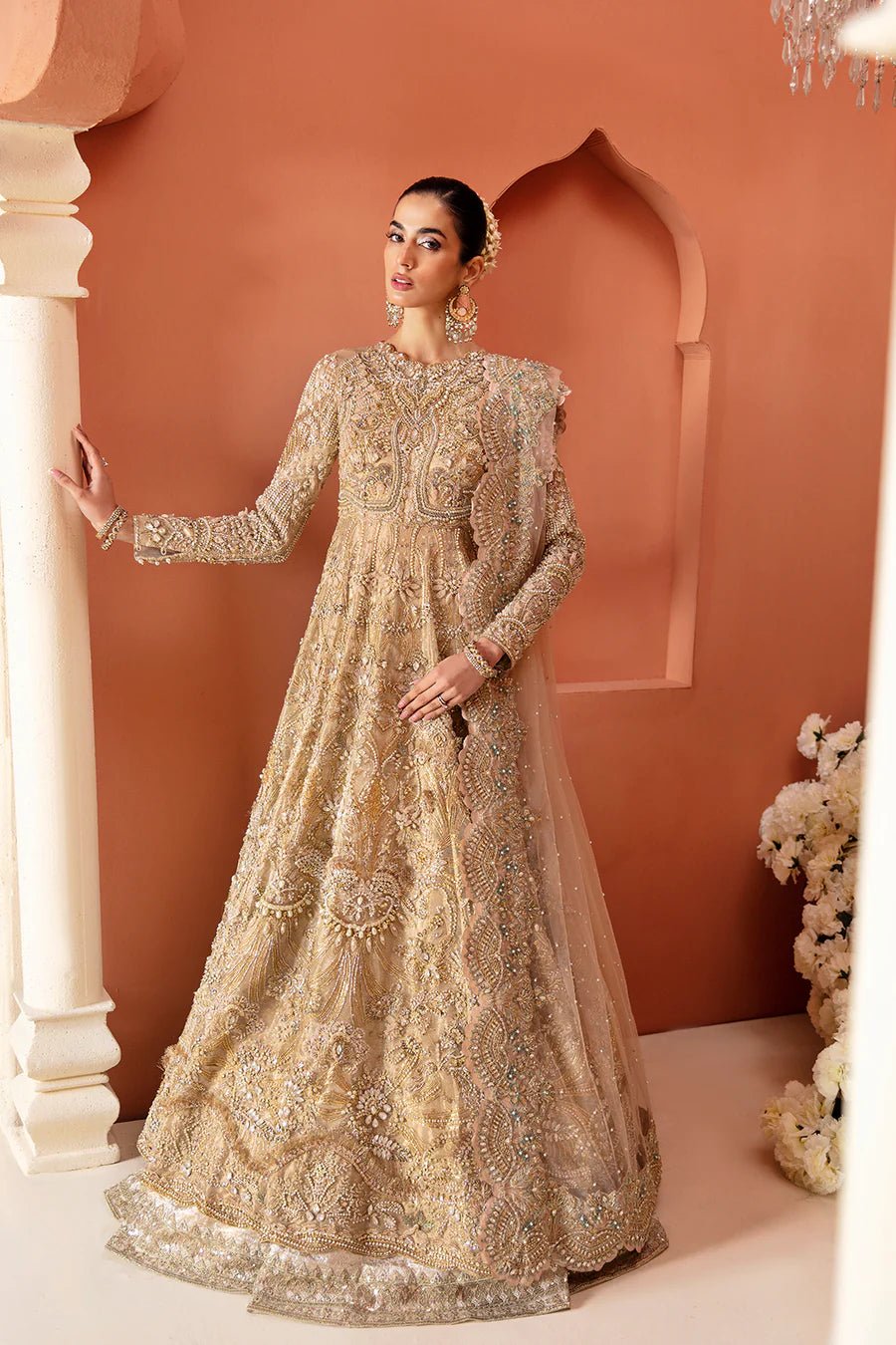 Model in Mysie By Tahira's Durre dress, a stunning golden bridal gown, Pakistani clothing artistry in the UK.