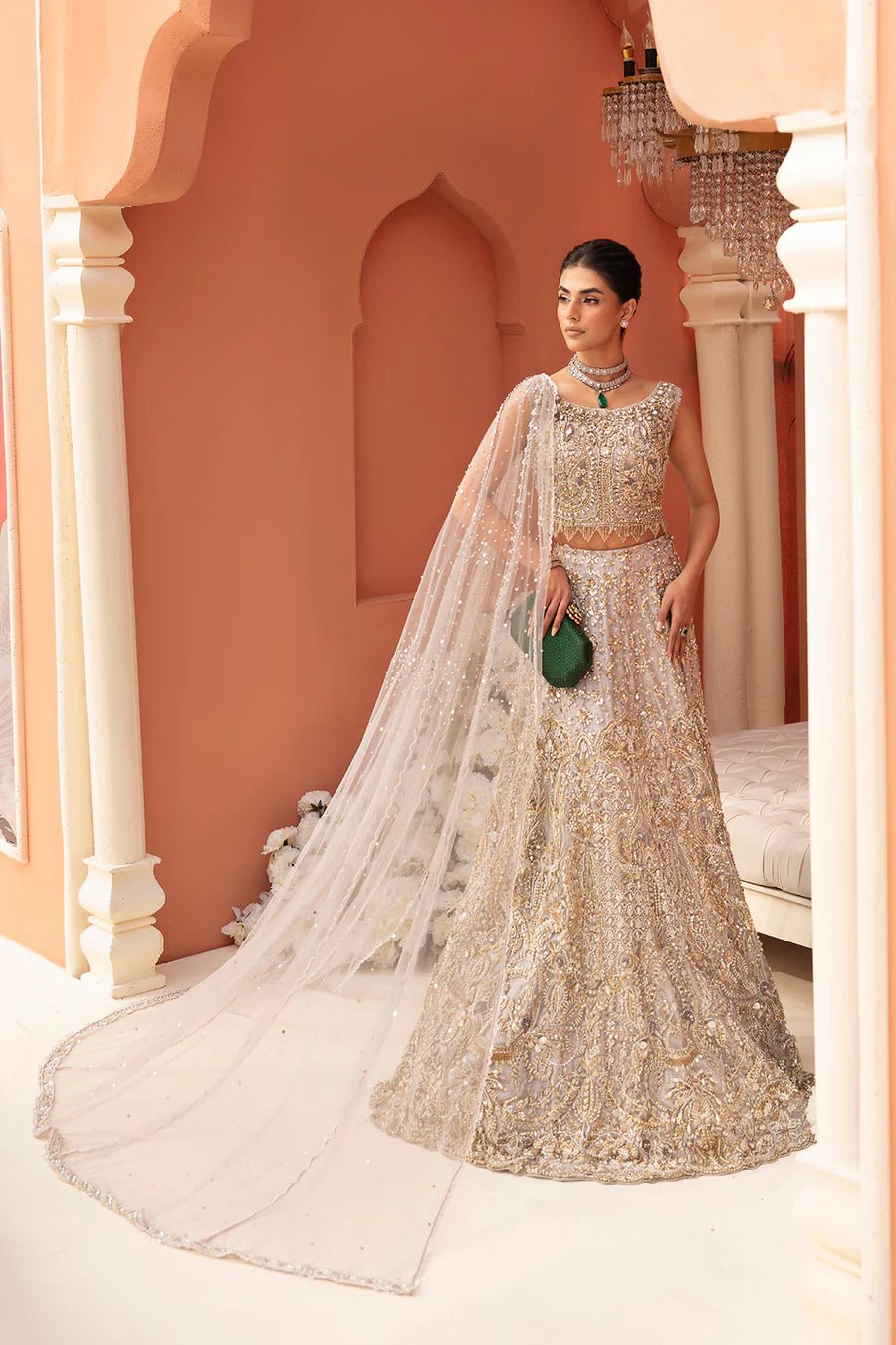 Model wearing golden Juliette bridal gown by Mysie By Tahira, epitome of luxury Pakistani clothes UK.