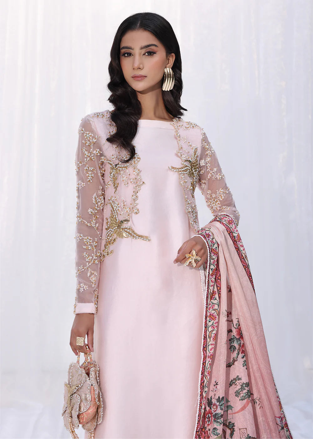 Model wearing powder pink embroidered dress with sheer sleeves and printed dupatta from Musferah Saad Moonlit Glam, Pakistani Luxury pret online in UK.