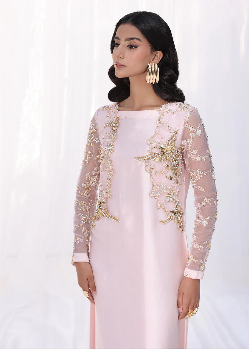 Model wearing powder pink embroidered dress with sheer sleeves and printed dupatta from Musferah Saad Moonlit Glam, Pakistani Luxury pret online in UK.