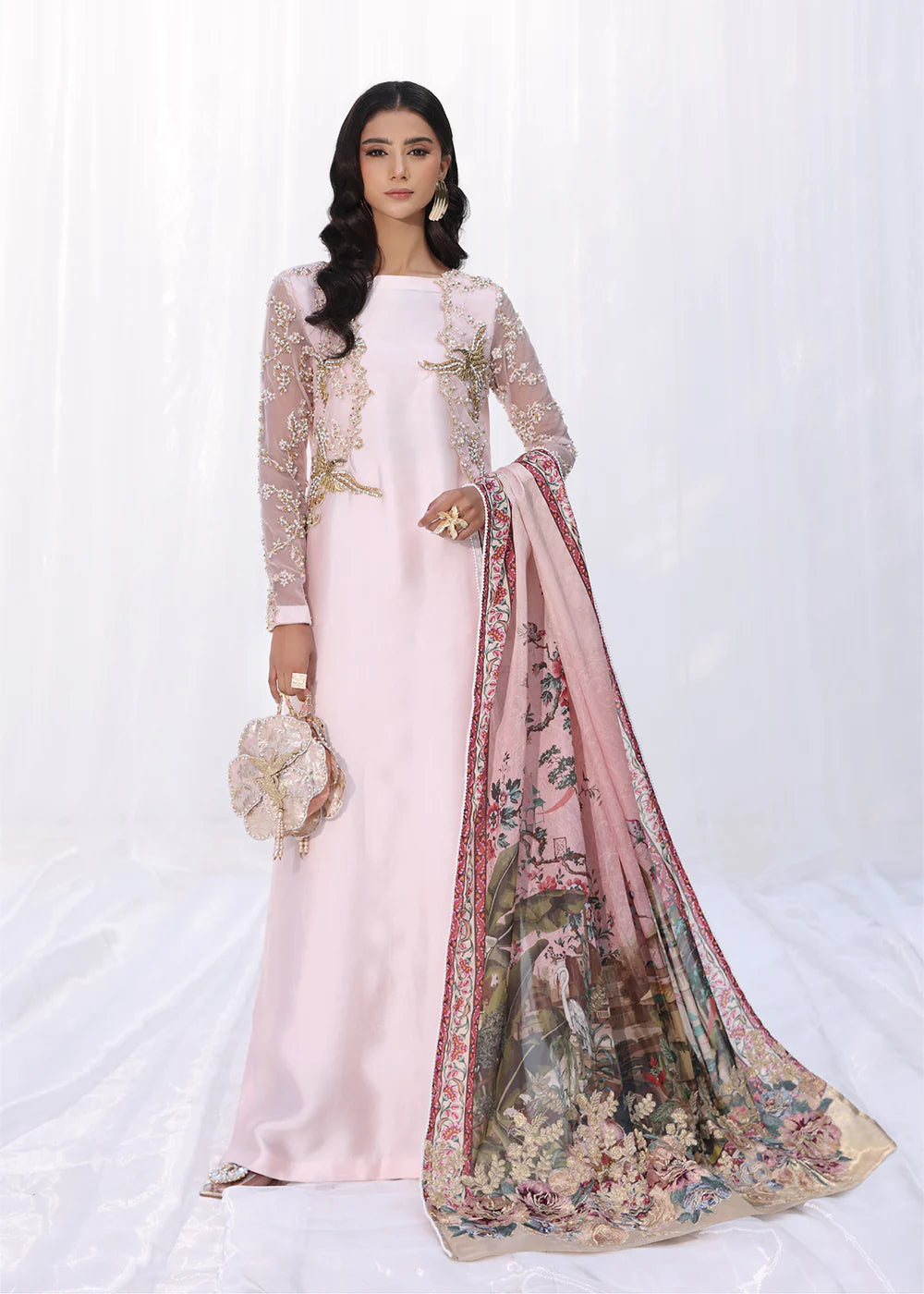 Model wearing powder pink embroidered dress with sheer sleeves and printed dupatta from Musferah Saad Moonlit Glam, Pakistani Luxury pret online in UK.
