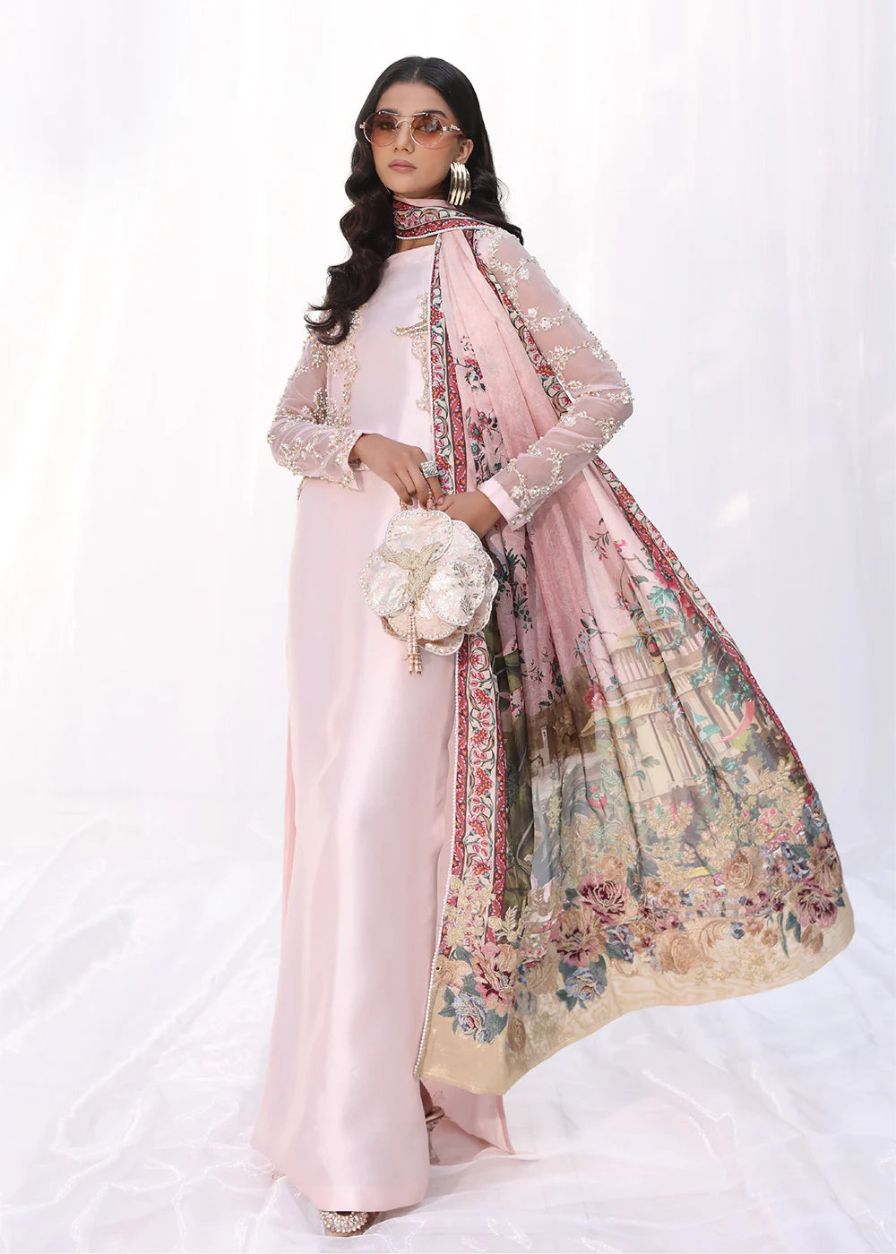 Model wearing powder pink embroidered dress with sheer sleeves and printed dupatta from Musferah Saad Moonlit Glam, Pakistani Luxury pret online in UK.