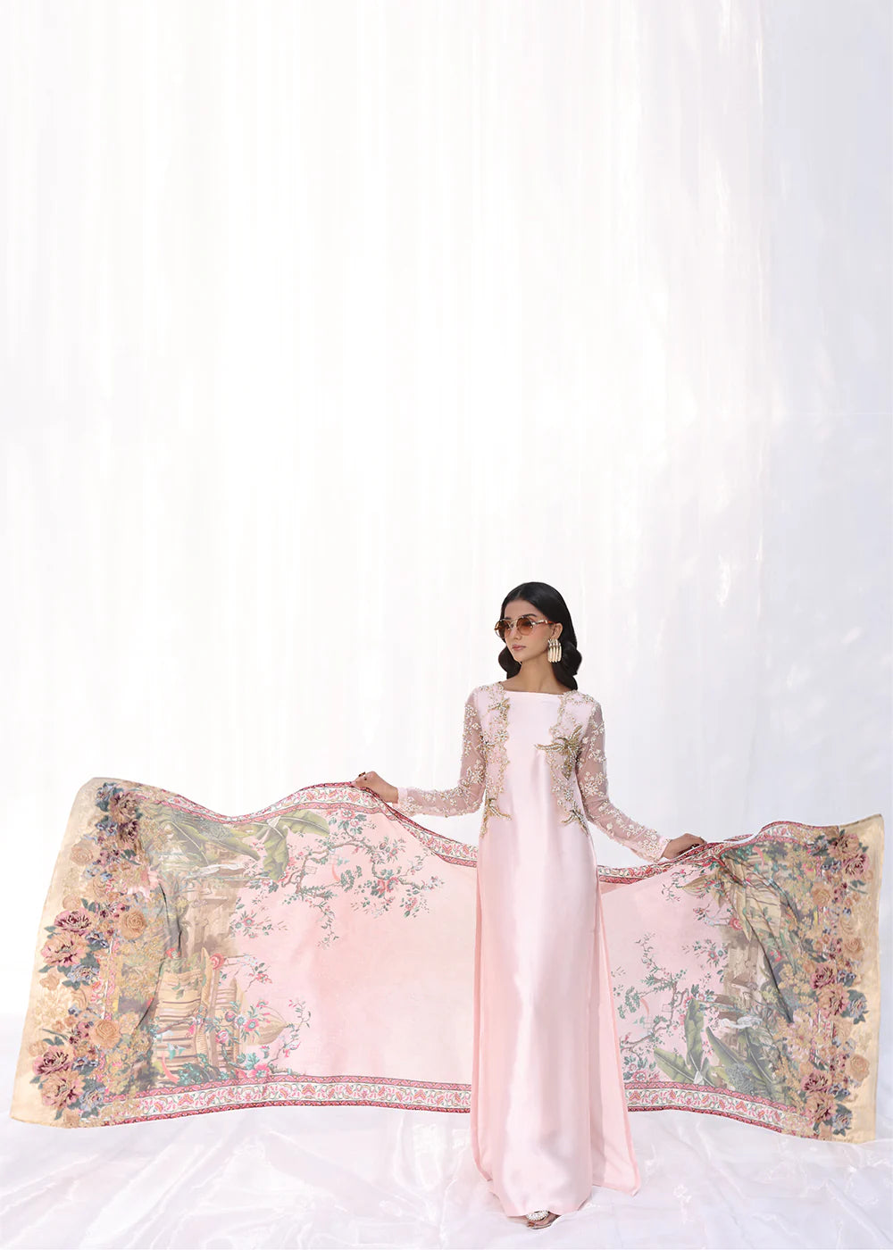 Model wearing powder pink embroidered dress with sheer sleeves and printed dupatta from Musferah Saad Moonlit Glam, Pakistani Luxury pret online in UK.