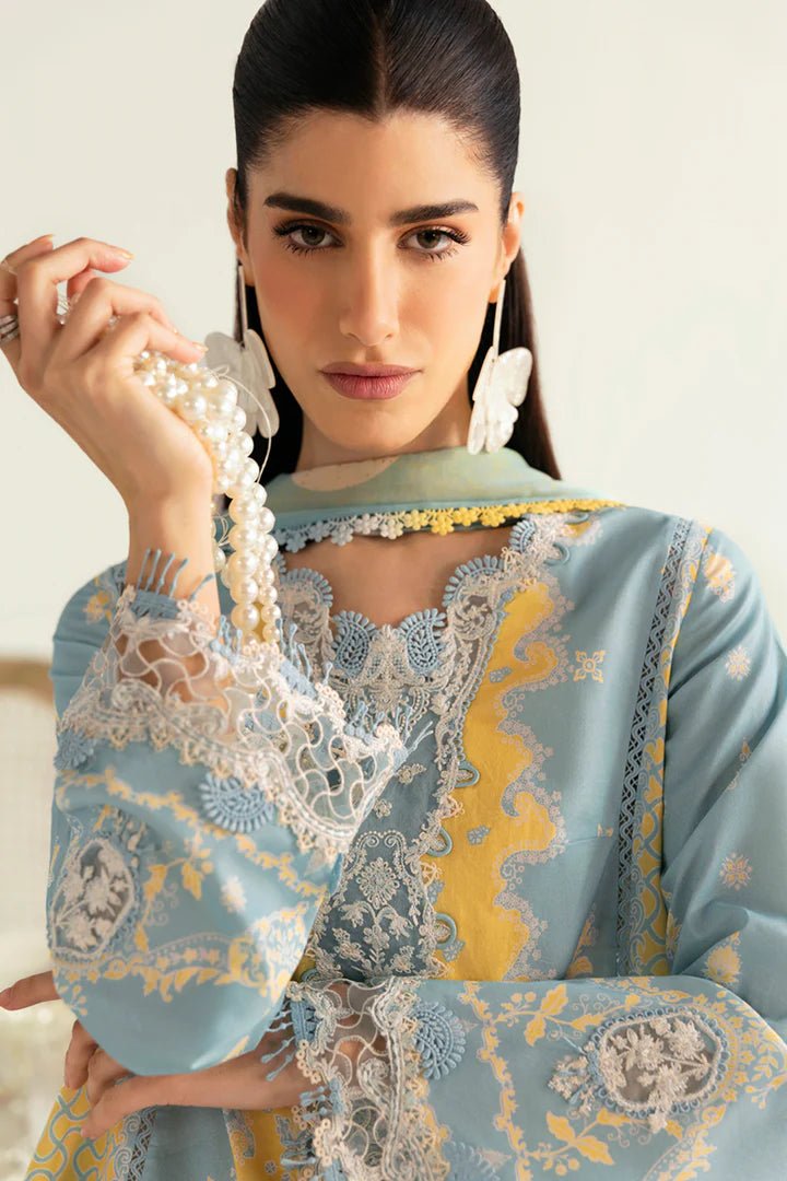 Model wearing blue PQ - 06 Elva dress from Qalamkar, a stylish Pakistani lawn suit perfect for summer clothes and lawn suits in the UK.