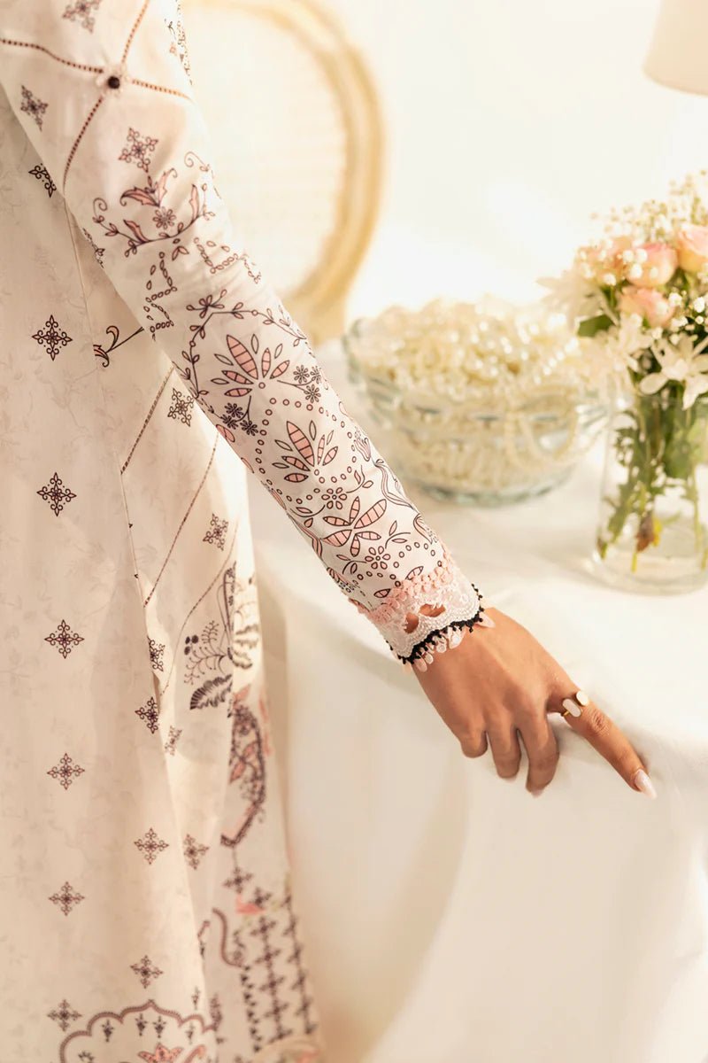 Model wearing Qalamkar Qprints '25 PQ - 09 Lyra dress in white with intricate embroidery and pastel detailing. Shop Pakistani clothes online in the UK now.