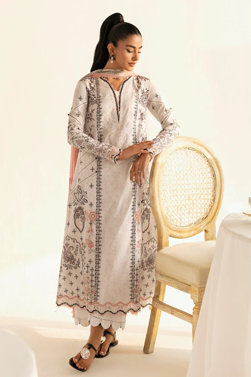 Model wearing Qalamkar Qprints '25 PQ - 09 Lyra dress in white with intricate embroidery and pastel detailing. Shop Pakistani clothes online in the UK now.