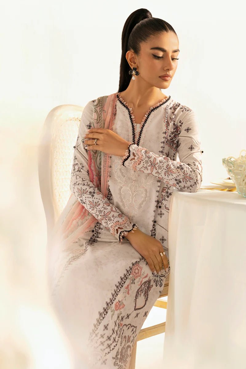 Model wearing Qalamkar Qprints '25 PQ - 09 Lyra dress in white with intricate embroidery and pastel detailing. Shop Pakistani clothes online in the UK now.