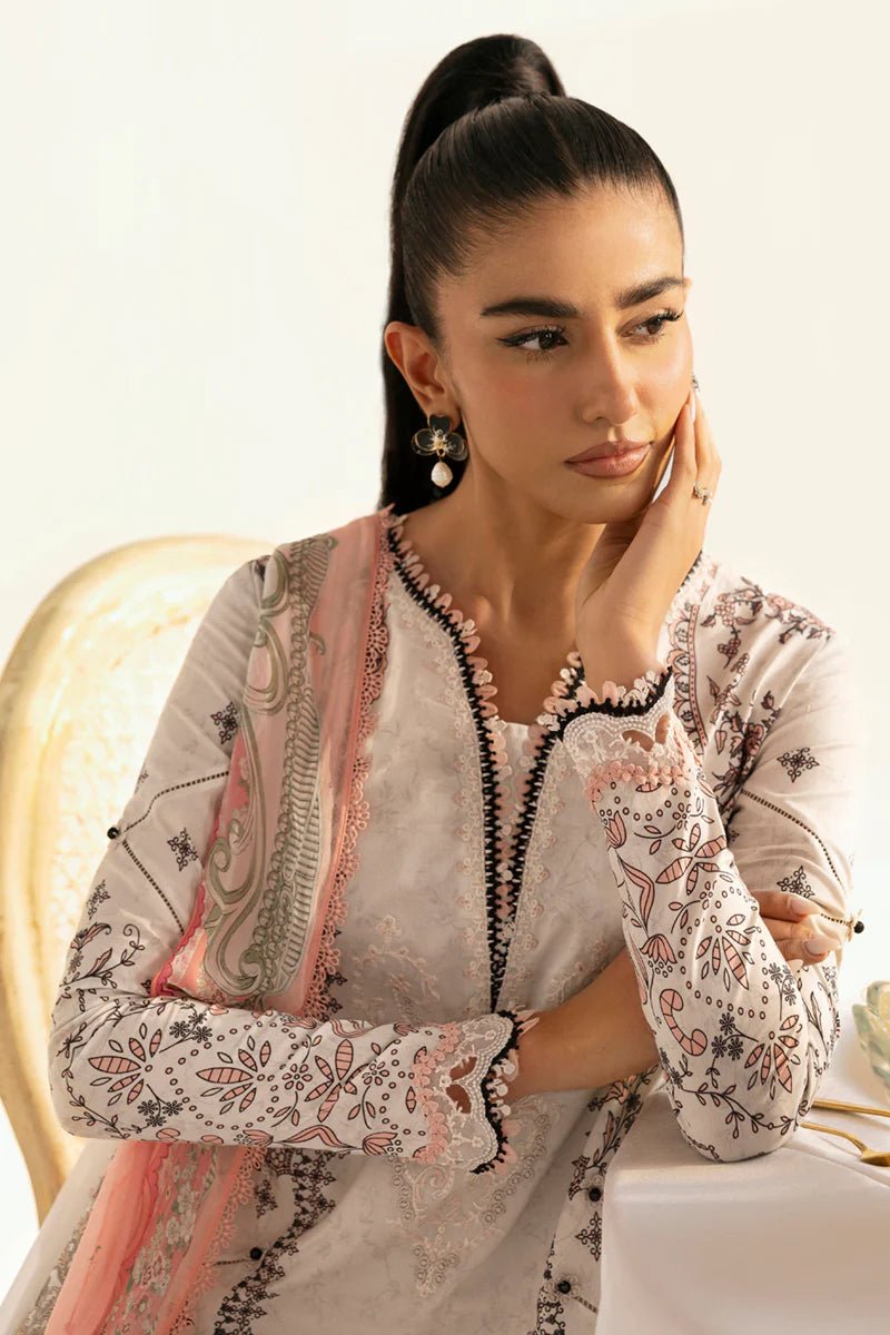 Model wearing Qalamkar Qprints '25 PQ - 09 Lyra dress in white with intricate embroidery and pastel detailing. Shop Pakistani clothes online in the UK now.