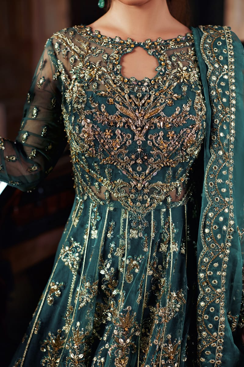 Model wearing Qalamkaar Shadmani Luxury Formals '24 Hala SH - 06 dress in deep teal with intricate gold embellishments. Shop Pakistani bridal dresses online in the UK now.