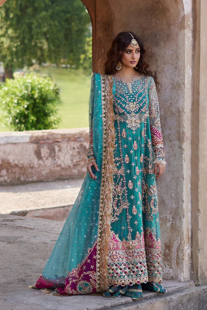 Model wearing Qalamkaar Shadmani Luxury Formals '24 Sama SH - 03 dress in teal with intricate gold embroidery. Shop Pakistani bridal dresses online in the UK now.