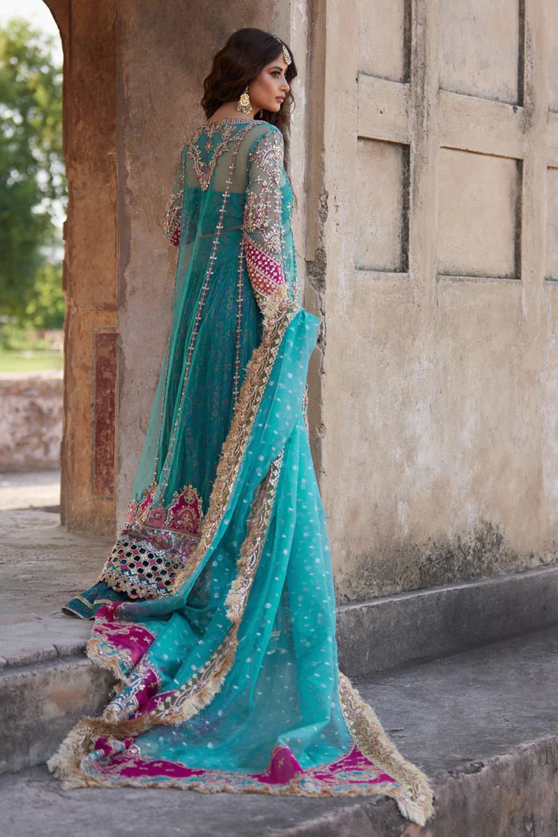 Model wearing Qalamkaar Shadmani Luxury Formals '24 Sama SH - 03 dress in teal with intricate gold embroidery. Shop Pakistani bridal dresses online in the UK now.