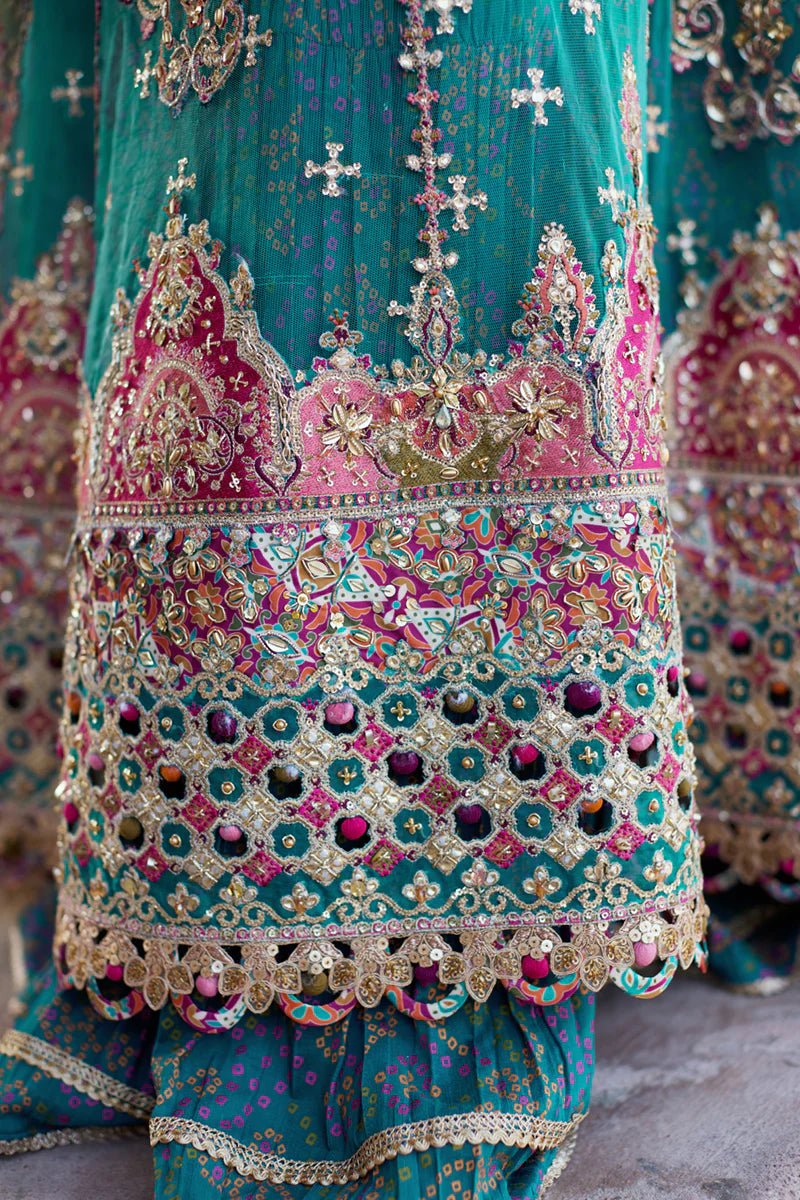 Model wearing Qalamkaar Shadmani Luxury Formals '24 Sama SH - 03 dress in teal with intricate gold embroidery. Shop Pakistani bridal dresses online in the UK now.