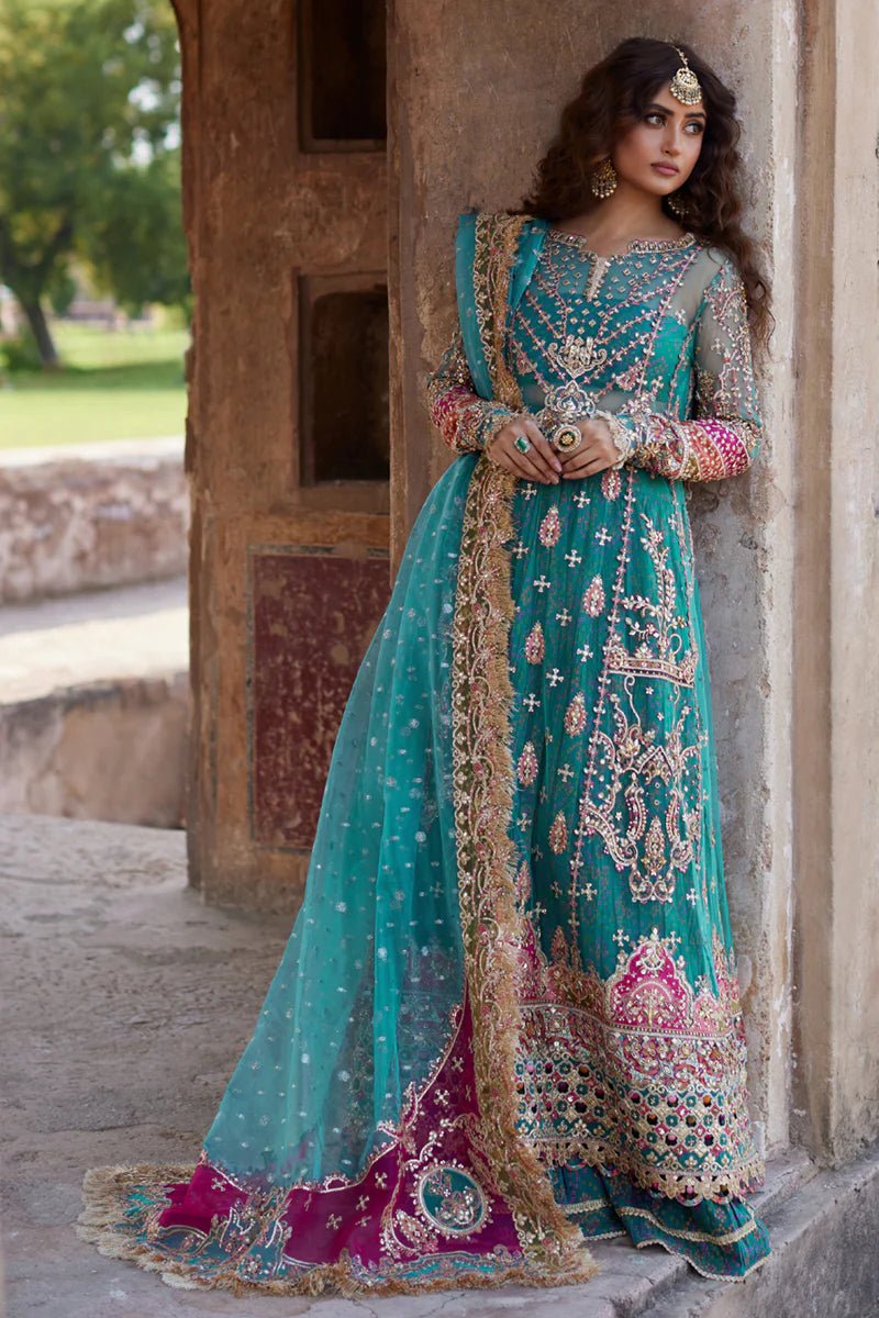 Model wearing Qalamkaar Shadmani Luxury Formals '24 Sama SH - 03 dress in teal with intricate gold embroidery. Shop Pakistani bridal dresses online in the UK now.