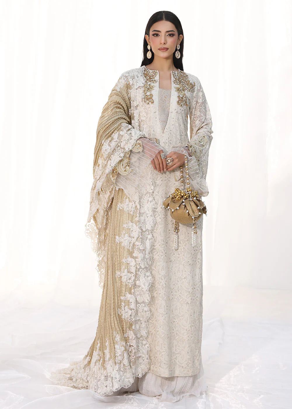 Model wearing off-white and gold embellished dress with lace detailing and dupatta from Musferah Saad Royal Pearl, Pakistani Luxury pret in UK.