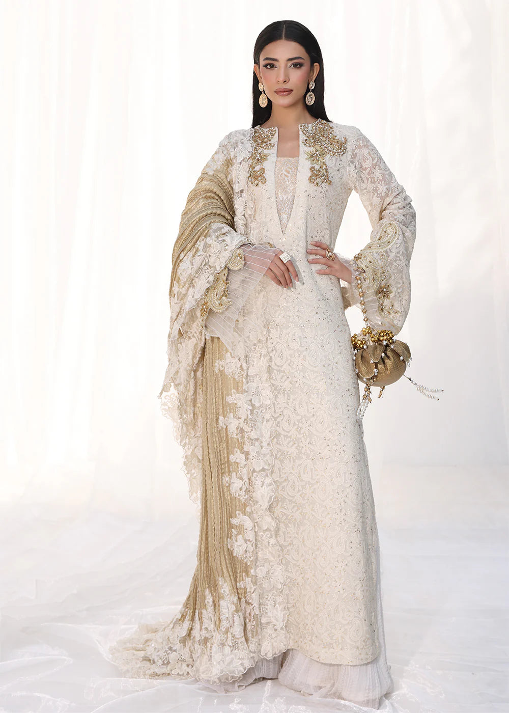 Model wearing off-white and gold embellished dress with lace detailing and dupatta from Musferah Saad Royal Pearl, Pakistani Luxury pret in UK.
