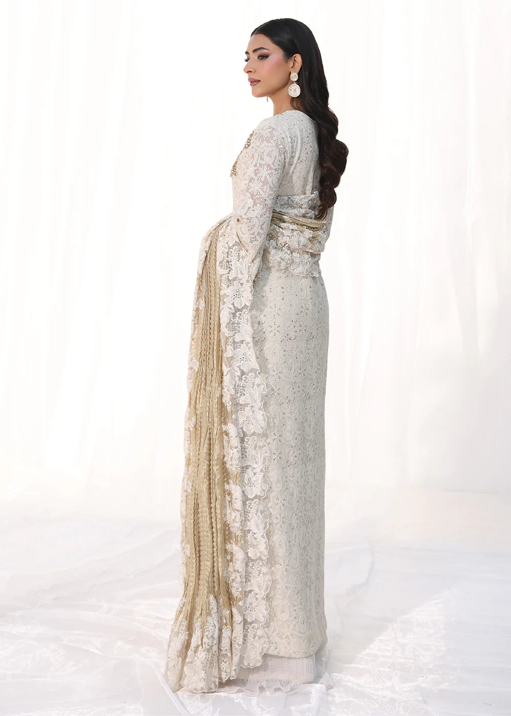 Model wearing off-white and gold embellished dress with lace detailing and dupatta from Musferah Saad Royal Pearl, Pakistani Luxury pret in UK.