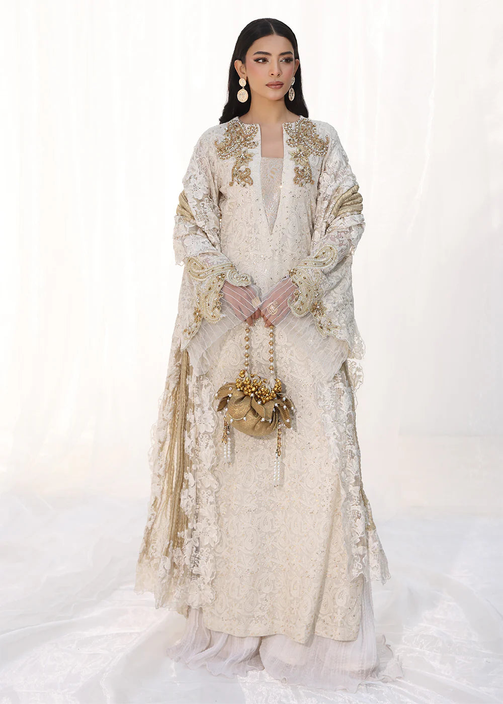 Model wearing off-white and gold embellished dress with lace detailing and dupatta from Musferah Saad Royal Pearl, Pakistani Luxury pret in UK.