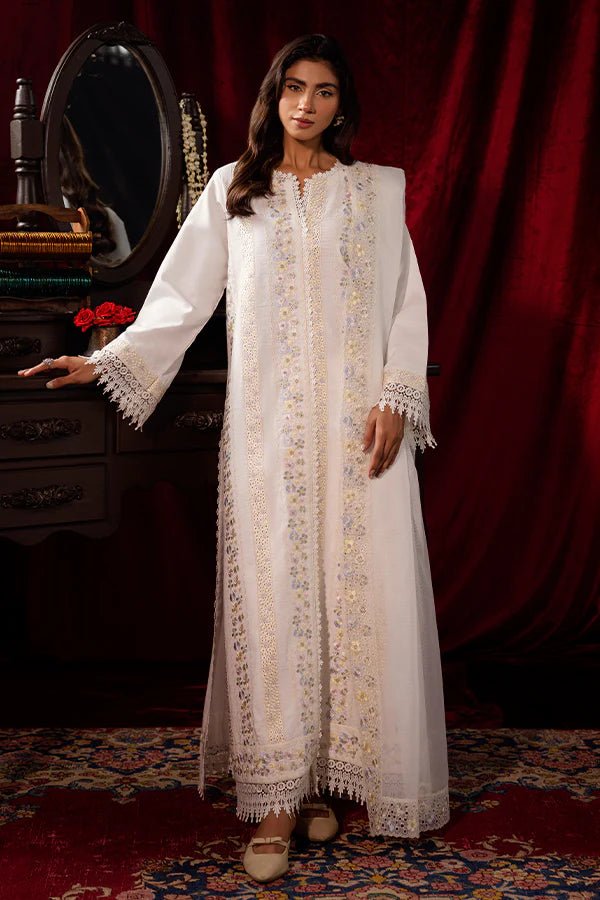 Model wearing a white Pearlescent dress from Saffron, adorned with intricate embroidery, ideal for winter, showcasing Pakistani designer clothes online in the UK.