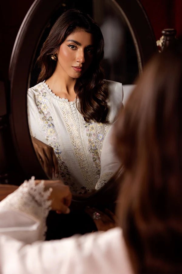 Model wearing a white Pearlescent dress from Saffron, adorned with intricate embroidery, ideal for winter, showcasing Pakistani designer clothes online in the UK.